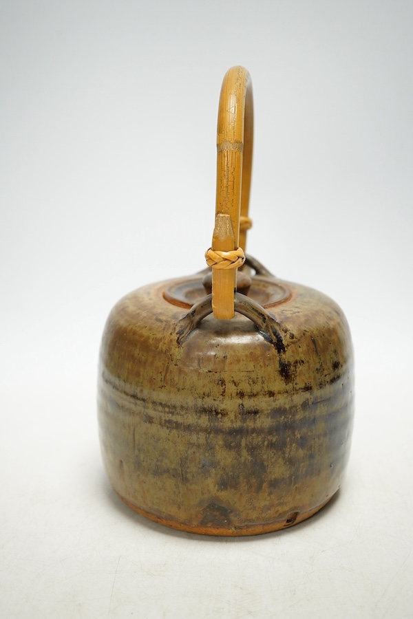 Pierre Culot (Belgian, 1938-2011), a studio pottery teapot with bamboo handle, stamped to the foot rim, 23cm high. Condition - fair to good, minor chipping